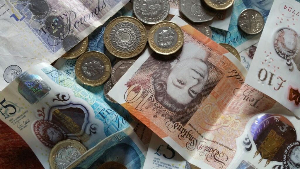 a pile of notes and coins in various denominations