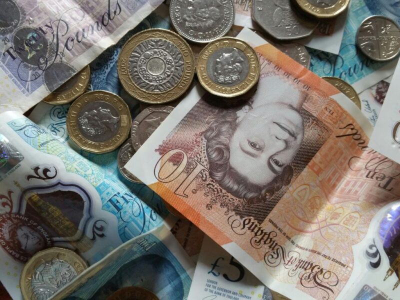 a pile of notes and coins in various denominations