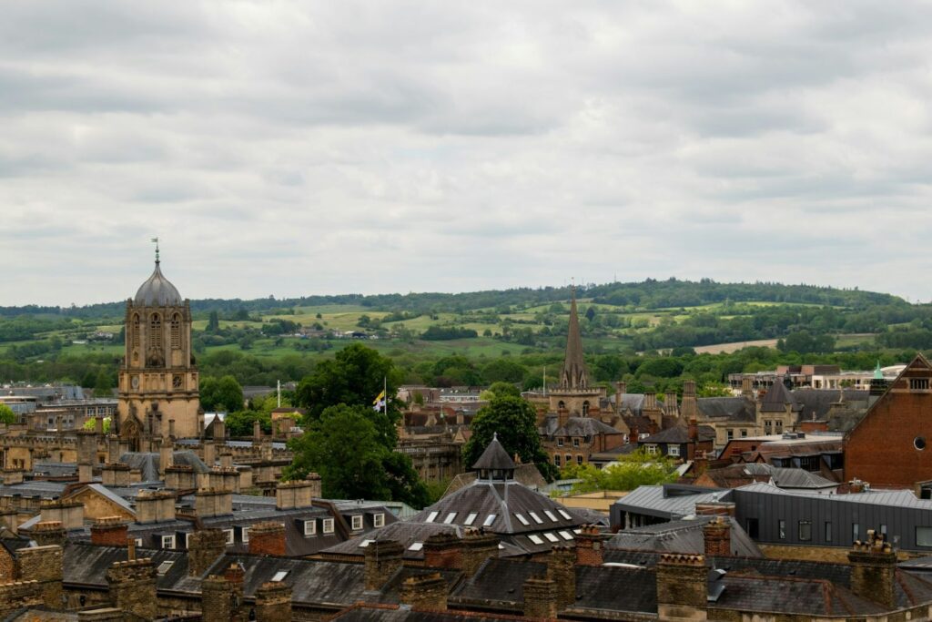 A view across the city of Oxford with rolling hills in the background