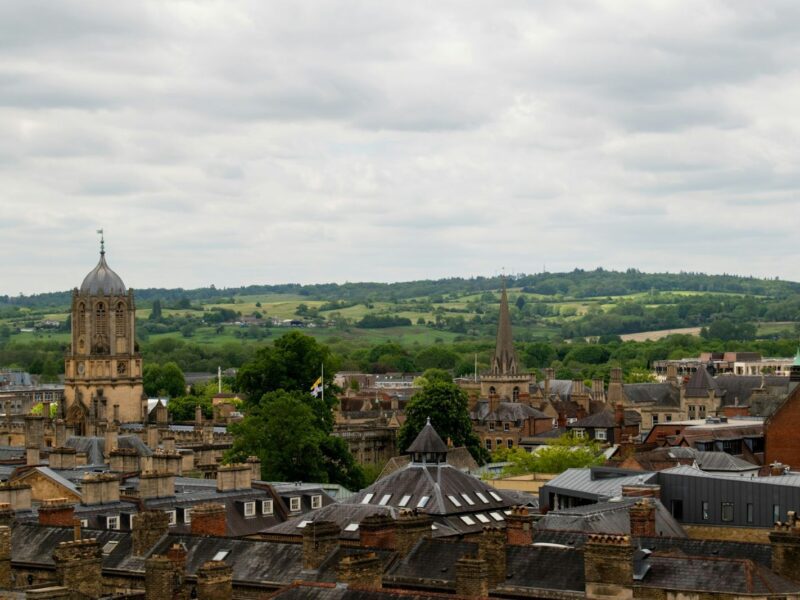 A view across the city of Oxford with rolling hills in the background