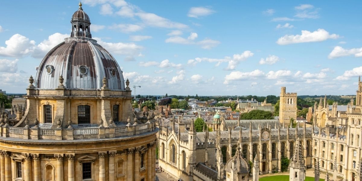 A view looking out across the rooftops of Oxford City on a sunny day with partly cloudy sky