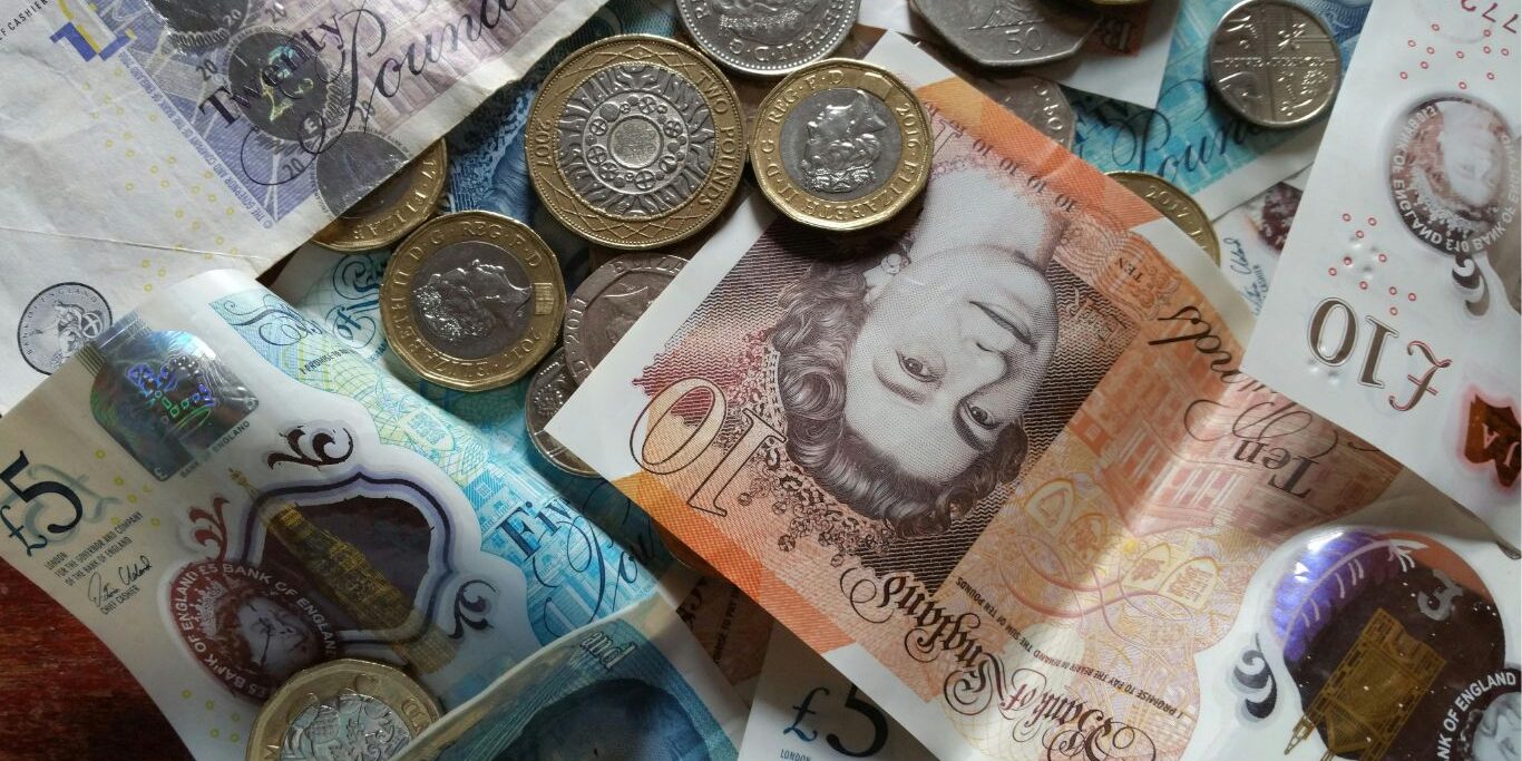 a pile of notes and coins in various denominations